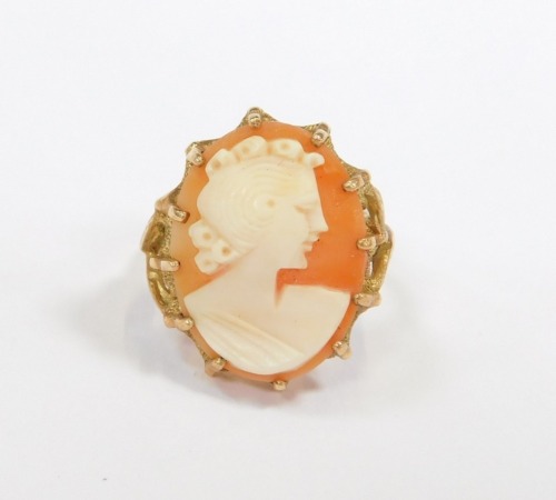 A 9ct gold cameo dress ring, the oval cameo depicting figure with scrolling hair, in a raised basket with leaf moulded shoulders, size N½, 6.6g all in.