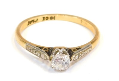 A diamond solitaire ring, the round brilliant cut diamond approx 0.15ct, in platinum claw setting, with platinum etched shoulders, on a yellow metal band stamped 18ct plat, size N, 2.3g all in.