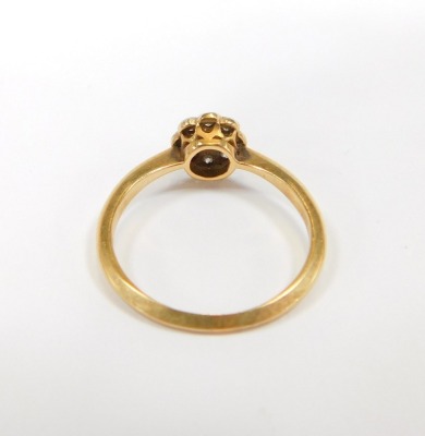 An 18ct gold diamond dress ring, the central floral cluster set with tiny diamonds, in rub over platinum setting, on a yellow metal band stamped 18, size N, 2.7g all in. - 2