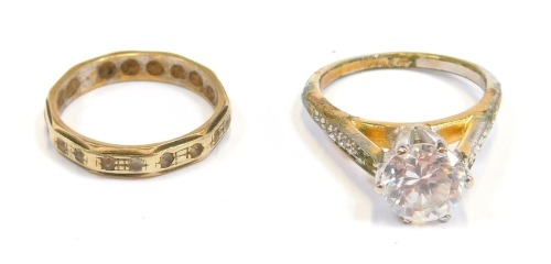 A 9ct gold eternity ring, set with tiny diamonds, on hammered design band, 2.1g all in, and a costume ring. (2)