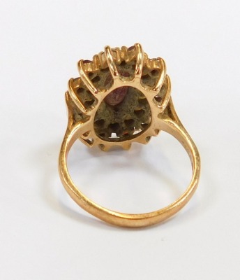 A 9ct gold cluster ring, the oval cluster set with garnet and seed pearls, each in claw setting, on a yellow metal band, size P, 5.8g all in. - 2