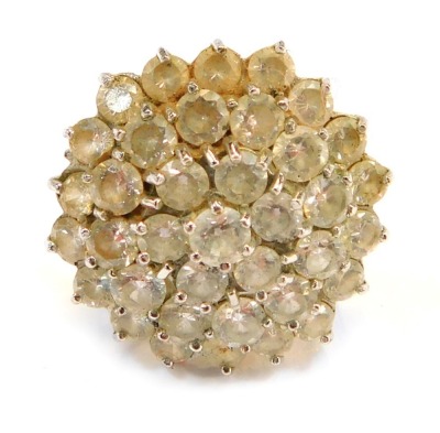 A 9ct gold CZ cluster ring, the chunky design with halo of CZ stones, in a raised basket, size R, 8.3g all in.