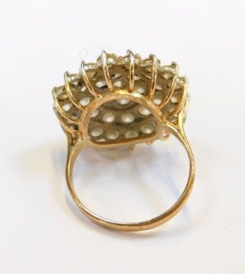 A 9ct gold CZ cluster ring, the chunky design with halo of CZ stones, in a raised basket, size R, 8.3g all in. - 2