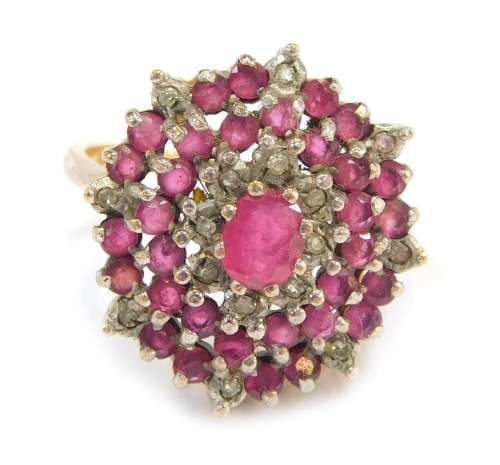 A 9ct gold cluster ring, the circular cluster set with halos of CZ and rubies, size P½, 4.9g all in.