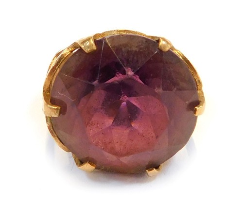 A 9ct gold dress ring, set with purple paste stone, in a chunky raised basket setting, ring size O, 10.1g all in.