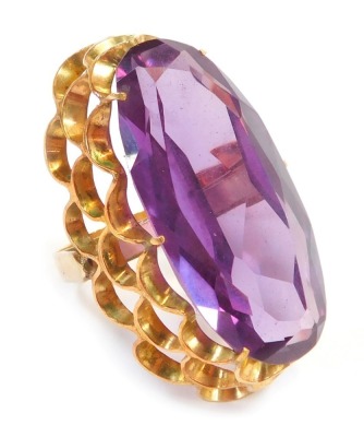 A dress ring, with oval amethyst in claw setting, with three layered fluted shank, yellow metal stamped 14K, ring size Q, 19.3g all in.