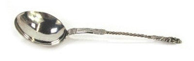 A Continental white metal serving spoon, with circular plain bowl, twisted stem and cast Virgin Mary and child terminal, 1.01oz, 18cm long.