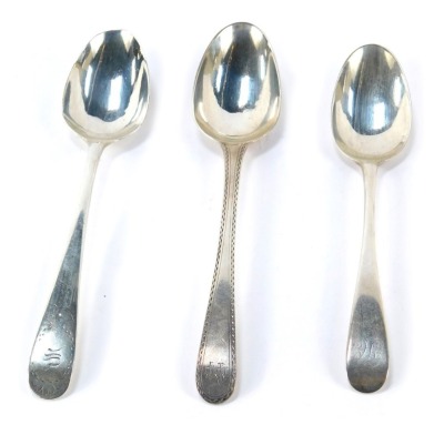 Three Georgian silver dessert spoons, comprising an Old English pattern example with bright cut decoration, London 1787, and two further spoons, initial engraved, hallmarks rubbed, 1.50oz,