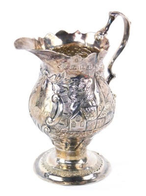 A Victorian silver cream jug, the fluted spout, with an embossed body bearing ducks, buildings and floral scrolls, with a cartouche inscribed SH 9th May 1833, maker NAAS, London 1852, 10cm high, 2.58oz.