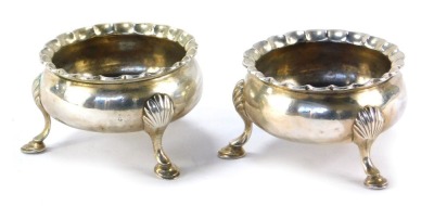 A matched pair of Victorian silver salts, each with a piecrust border, on shell capped tripod feet, maker RHAH, London 1847 and 1848, 3.65oz. (2)