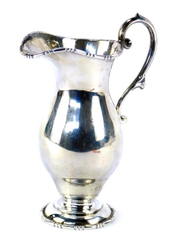 A Edward VII silver cream jug, with a beaded and fluted spout, with acanthus leaf handle, on a stepped foot, maker WA, Birmingham 1906, 12cm high, 5.24oz.