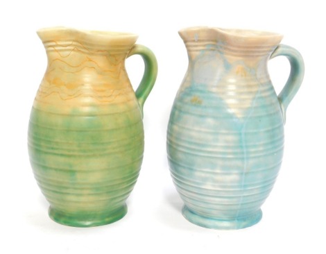 Two Beswick pottery jugs, of cylindrical banded form, in mottled blue and green colour way, printed marks, 24cm high.