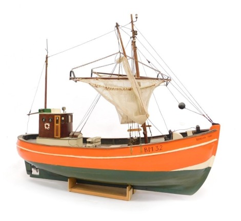 A 20thC model fishing boat, painted orange and green, named The Rebecca Mary, BM32, on stand, 45cm high.