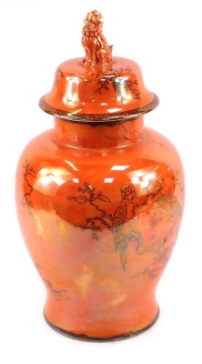 WITHDRAWN PRE SALE BY VENDOR. A Carltonware orange lustre jar and cover, of large proportion with dog of fo handle and hand painted black detail of parrots, on an orange ground, 49cm high. (AF)