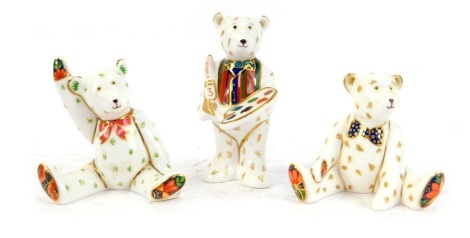 Three Royal Crown Derby porcelain Teddy Bear paperweights, comprising Artist Claude, Teddy Bear Edward, and Teddy waving Victoria, boxed. (3)