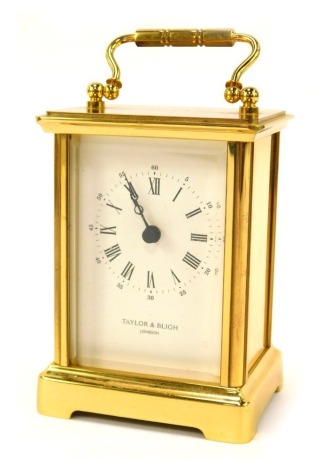 A Taylor and Bligh of London brass carriage clock, with white enamel Roman numeric dial, twin handle, 11cm high, 8cm wide, 7cm deep.