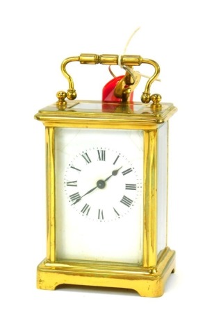 A 20thC brass cased carriage clock, a rectangular white enamel dial bearing Roman numerals, barrel key wind movement, the case of typical form, 11cm high, with key.