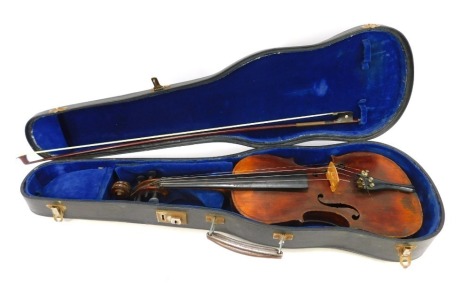 A late 19th/early 20thC two piece split back violin, 56cm long, with bow, in fitted case. NB. We have specific vendor instructions to sell WITHOUT RESERVE.