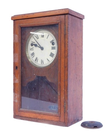 An early 20thC oak cased wall clock, the circular enamel dial bearing Roman numerals, eight day movement, with pendulum, the case 57cm high.