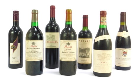 Seven bottles of vintage wine, comprising Roodeberg 2008, Pinotage 2009, Merlot del Vento 1996, Penfold's Rawson's Retreat Ruby Cabernet, and Shiraz, KWV Roodeberg 1988, and Nuits Saint Georges 1994.