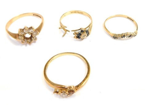 Four dress rings, comprising a 9ct gold dress ring frame, lacking centre zone surrounded by tiny white stones, a 9ct gold cz and sapphire wishbone ring, 9ct gold sapphire cluster, with broken shank, and a three stone dress ring lacking stone, 6.4g all in.