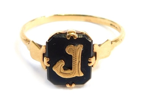 A signet ring, with black agate panel, with raised initial J, on a plain band, ring size O½, 2g all in, misshapen.