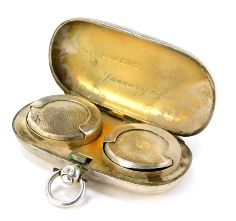 A silver double coin case, of oblong oval form, with initials HBB, and a sprung bound interior, 1.28oz.