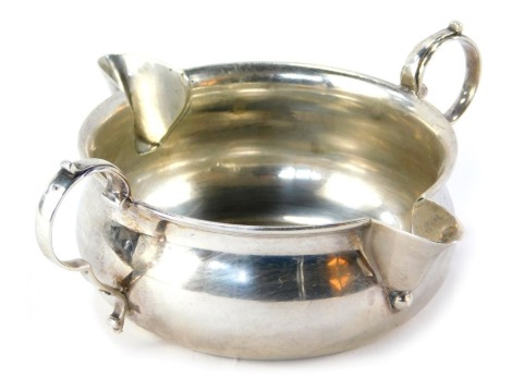 An Edward VII silver feeding cup, with two moulded handles and two spouts, on a plain design, London 1902, 2.35oz.