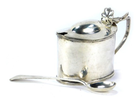 An Edward VII silver mustard pot, of oval form, with a fluted lid and pierced thumb piece, maker TH, with blue glass liner, Birmingham 1903, and a later spoon, 3.42oz.