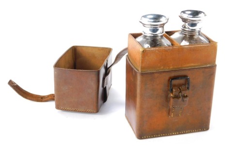 A Drew and Sons of Piccadilly cased travel bottle set, with two rectangular cut glass travel bottles, each with a silver cork stopper, London 1908, 16cm high, 10cm wide, 6cm deep.