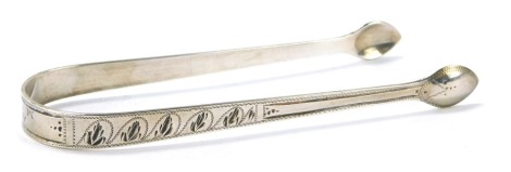 A pair of George V silver sugar nips, of engine turned leaf decoration, bearing the initials AME, London 1922, 1.16oz.