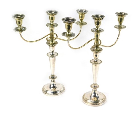 A pair of silver plated three branch candelabra, of beaded design, 45cm high.