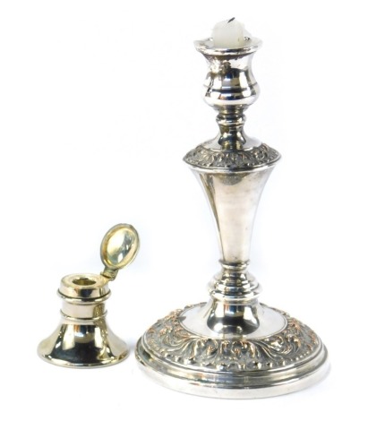 A silver plated inkwell, and a Neoclassical design plated candlestick, the inkwell 5.5cm high, the candlestick 23cm high. (2)