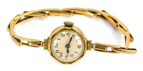 A 9ct gold lady's wristwatch, with small circular watch head with cream numeric dial, on expanding bracelet, 12g all in.