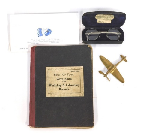 A Royal Air Force notebook for workshop and laboratory records, detailing practical valve timing, notes on engines, Panther engines, etc., named to SJ Armstrong, 1084783, together with a brass spitfire, and a pair of cased spectacles.