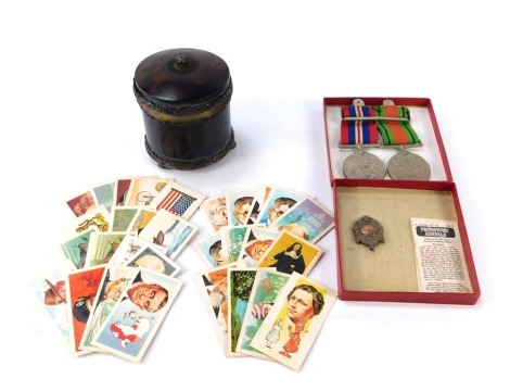 Two World War Two medals, comprising The 1939-45 War medal, and the Defence medal, together with a silver fob, a small quantity of cigarette cards, and a Goldsmiths and Silversmiths Company 112 Regent Street simulated tortoiseshell and plated dressing tab