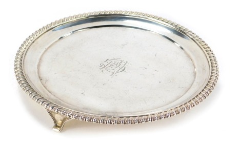 A Victorian silver card tray, with a fluted border and bearing the initials CM, retailer Thomas, London 1834, 16.40oz, 20.5cm diameter.