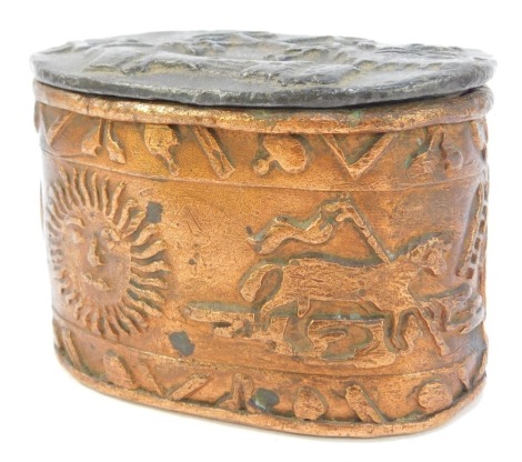 A 19thC lead tobacco jar, of compressed oval form, the lid decorated with cross keys, other motifs, etc, the base later painted copper colour, decorated with sun, egg timer, arched door, other motifs, etc, 8.5cm high.