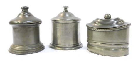 Three 19thC pewter tobacco jars, two of cylindrical form, the other of compressed cylindrical form, the largest 12cm high.