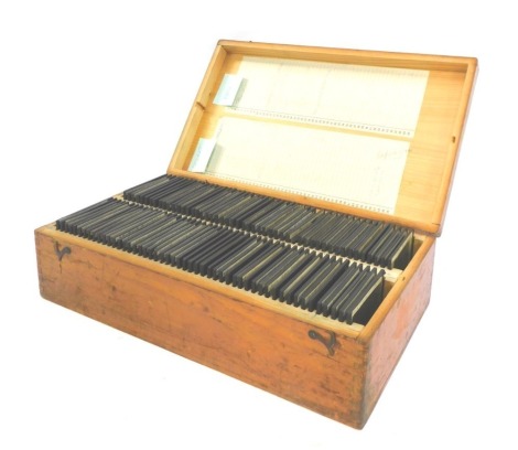 A pine case containing various slides, to include a Bach organ, Kremser Monument, various music rooms, opera houses, etc, the case 36.5cm wide.