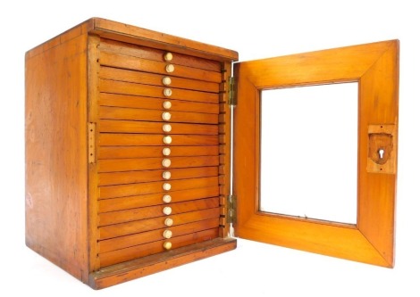 A late 19th/early 20thC specimen case, with glazed door enclosing various drawers, 28cm high.