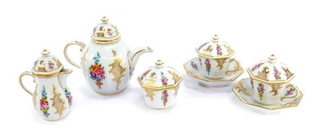 A 20thC Dresden porcelain chocolate tete-a-tete, comprising pot, lidded milk jug, lidded sugar bowl, and two cups and saucers with lids, pot 14cm high, each piece decorated with flowers against a white ground with gilt highlights.