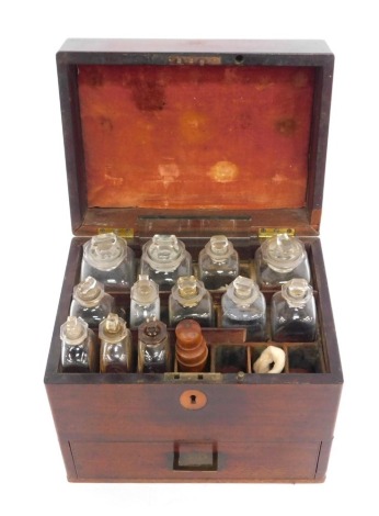 A 19thC mahogany Doctors chest, the hinged lid enclosing various glass bottles with labels, for Eucalyptus Oil, Gum Arabic, Burroughs Wellcome Laxative, etc, with lower drawer to base, the box 23cm high, 26cm wide, 19cm deep.