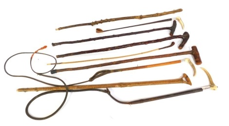 A group of walking sticks, to include wooden examples, simulated antler handles, riding crops, etc. (a quantity)