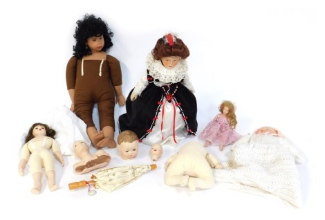 A group of bisque face dolls, varying sizes and designs.