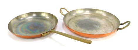 A Divertimenti of London copper frying pan, with brass handle, 26cm diameter, together with a two handled copper dish, 30cm diameter.