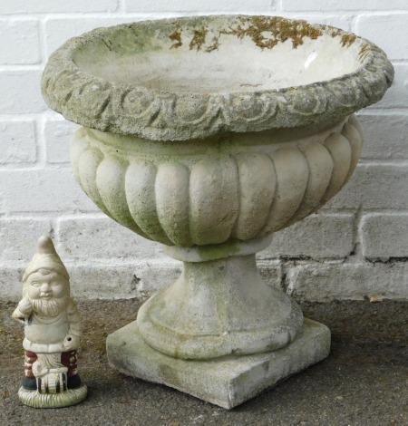 A composition garden planter, of cylindrical fluted form, on plinth base, 44cm high.