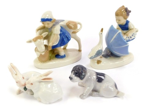 Two Royal Copenhagen porcelain figures, modelled as a seated puppy, 5cm high, and two rabbits sharing a piece of lettuce, 6cm high (AF), together with two similar figure groups.