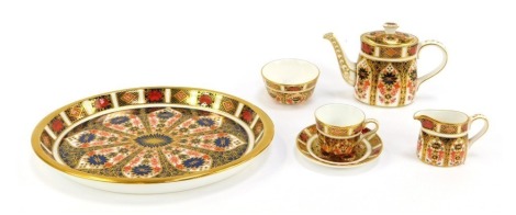 A Royal Crown Derby Imari pattern porcelain miniature tea service, comprising oval tray, 19cm wide, teapot, 6cm high, milk jug, sugar bowl, teacup and saucer, boxed.