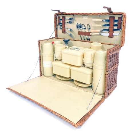 A mid century Coracle picnic hamper and contents, 56cm wide.